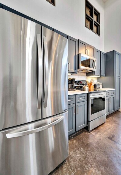 Stainless steel appliances in the kitchen of this one-bedroom, one-bathroom luxury rental condo in the historic Behrens building in downtown Waco within walking distance to the Silos, Baylor, and local museums.