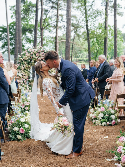 A couple kissing after their wedding ceremony at the Pointe at the Ritz Lake Oconee