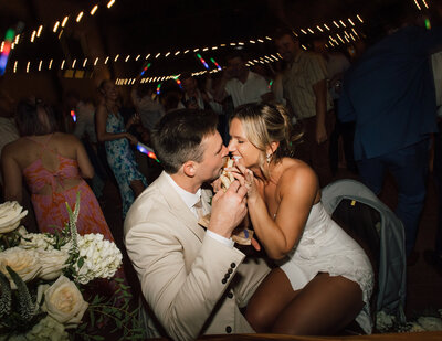 Bride and groom sharing a fun moment at their wedding reception, captured by a Scottsdale wedding photographer amidst the excitement of the celebration