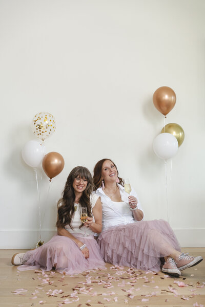 female-entreprenuer-celebration-barnd-photo-with-champagne-confetti-and-balloons