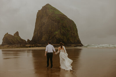 Couple holding hands on a rock formation