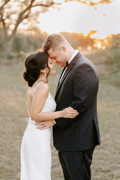 Bride and Groom during sunset  at Jacob's Well Vineyard Venue by Houston Wedding Photographer
