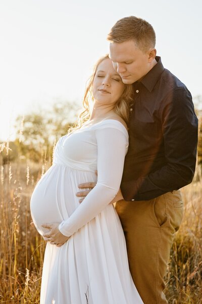 Husband and pregnant wife get photos taken for maternity session