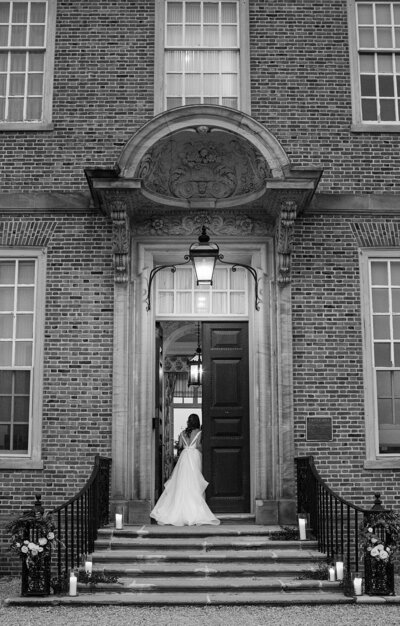 A bride walks through the doors of the Crane Estate in Ipswich. Deborah Zoe Photography.
