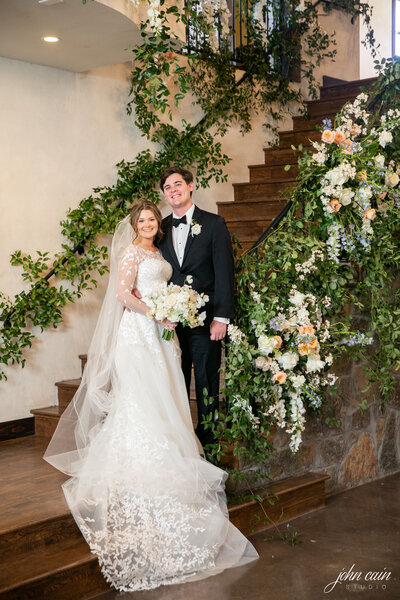 real Ma Maison wedding couple standing at bottom of grand stairs