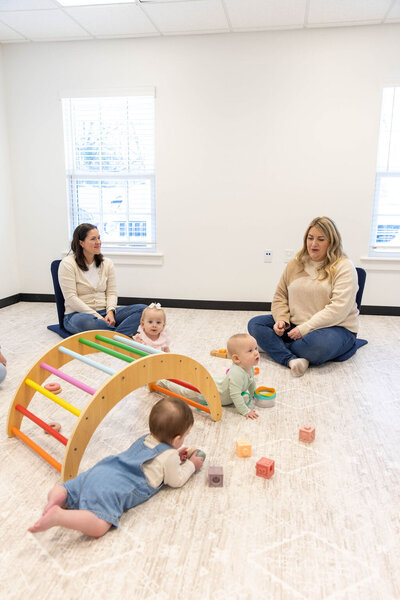 Two women playing with their babies on a play date