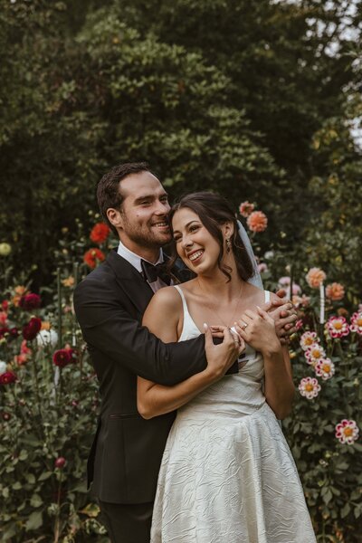 bride and groom  share romantic moment in floral field