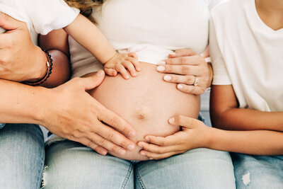 South Florida Maternity Photographer captures the whole family holding mom's belly