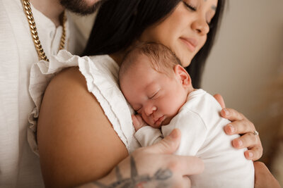 newborn baby in a white hammock swing