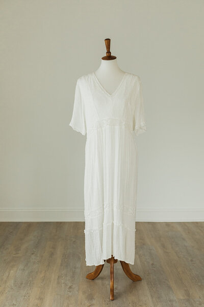 White dress with delicate dots in fabric & lace accents around bust