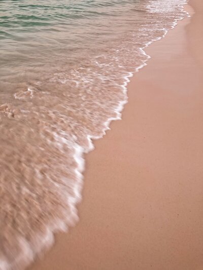 abstract of waves crashing onto a beach