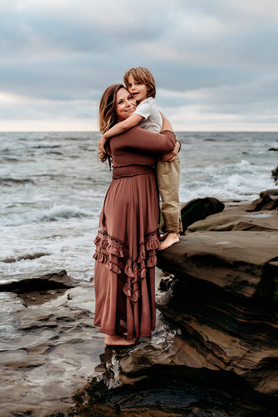 Mother embraces her son during Family Photos on Folly Beach in Charleston, SC.