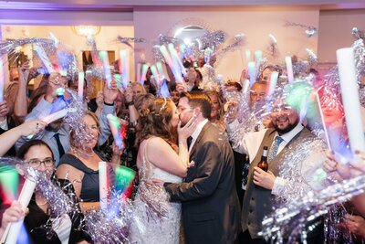 couple on the dance floor with guests surrounding them