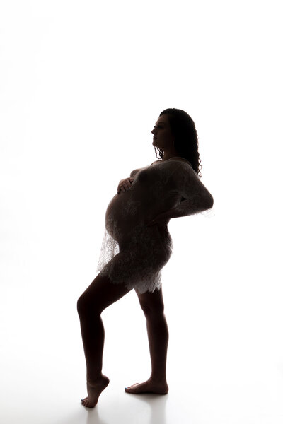 Maternity backlit profile silhouette of a beautiful mama