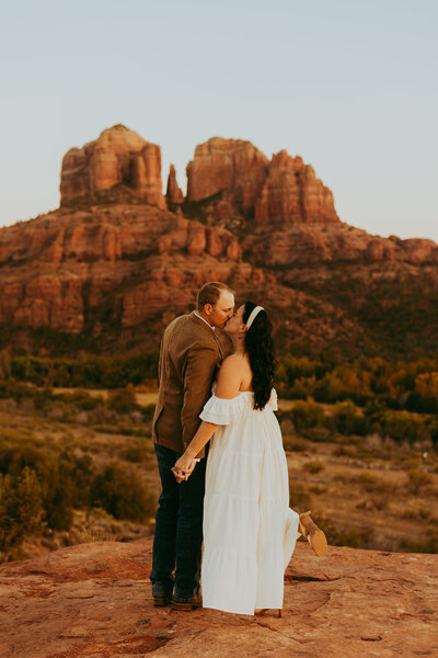 man and woman in front of cathedral rock in sedona arizona for engagement photos