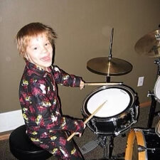 Child playing small drum set
