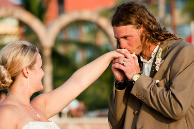 Groom kissing brides hand