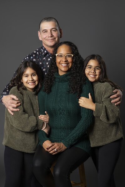 Edmonton studio family session with mom and kids sharing joyful hugs