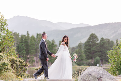bride and groom holding hands during their colorado elopement