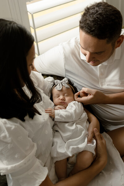 Mom and dad looking at their newborn baby