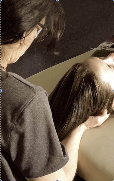 Photo with client during CranioSacral Therapy session.