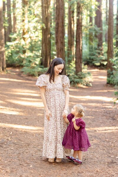 Mom and daughter holding hands with a beautiful smile 