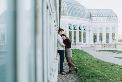 Couple holding each other, leaning on a wall at a park in Saint Paul, Minnesota.