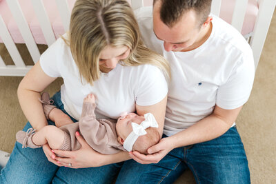 mom and dad holding baby girl by Bruna Firkins Photography