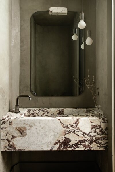 house-franc-toro-canyon-westlake-moody-bathroom-powder-room-remodel-renovation-calacatta-viola-marble-custom-stone-vanity-belgian-terracotta-floor-tile-plaster-walls-roman-clay-brizo-faucet-southern-electric-pendants-historic-neighborhood-austin-texas