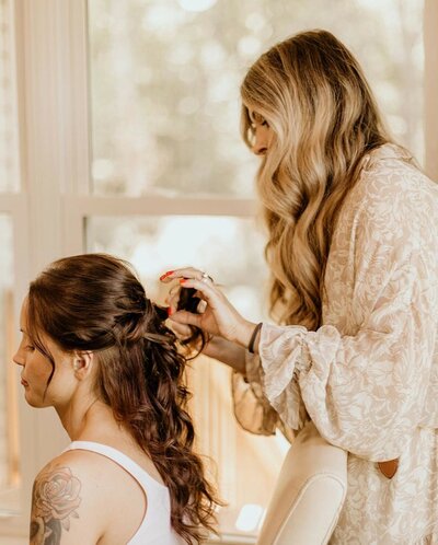woman styling other woman's hair