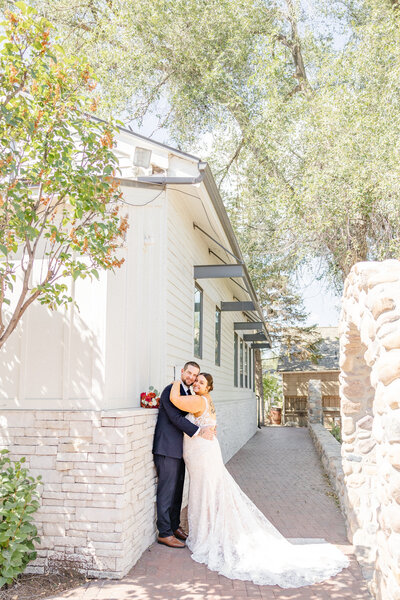 Recently married couple poses for stunning portrait at Gardner village in West Jordan Utah