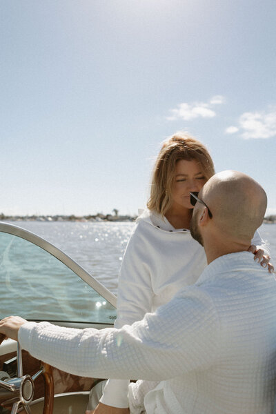 Couple on a boat on pacific ocean looking at eachother