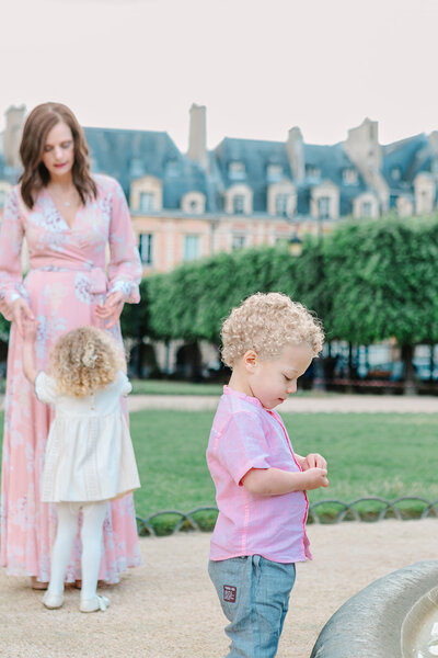 Mother, daughter and son at Marais Place Des Vosge during family photoshoot in Paris