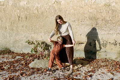 mom and son playing in the rocks