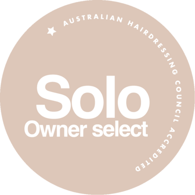 Australian Hairdressing Council accreditation badge in beige, featuring "Solo Owner Select" text and a minimalist star design.