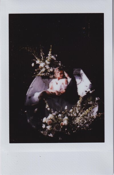 Bride and groom in a luxuriously decorated boat from a birdseye view in melbourne wedding surrounded by flowers