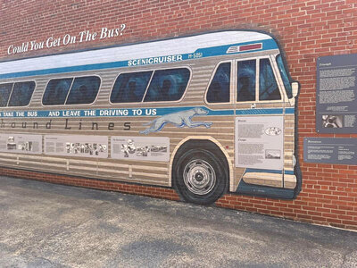 Mural of greyhound bus on brick wall