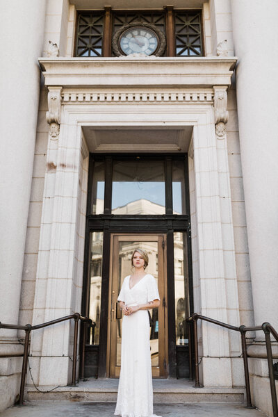 Bride standing in front of town hall building