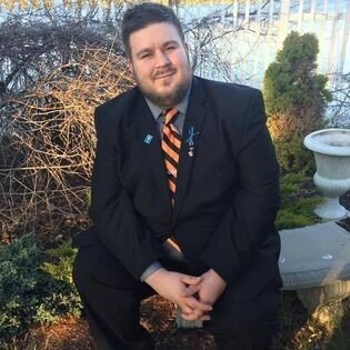 Zachary smiling in a suit