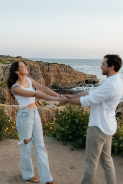 Couple holding hands on the Oregon coast.