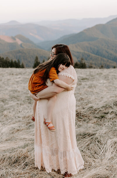 mom hugging toddler girl