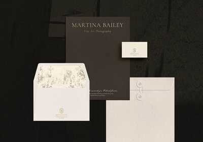 Flat lay of Martina Bailey fine art photography brand identity suite, featuring logo variations, business cards, letterhead, and soft bridal imagery in neutral tones.