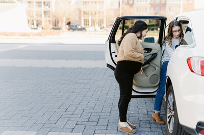 that car seat mom installing car seat with pregnant woman