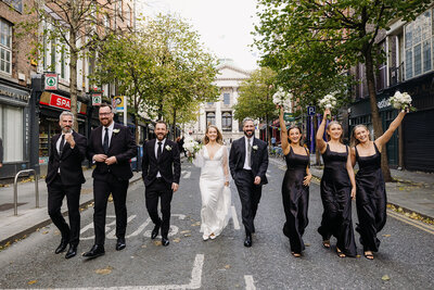 Bride and groom walking on path with The K Club in Kildare, Ireland in the background