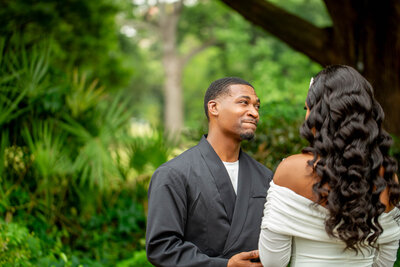 This elegant Black couple stands side by side after their elopement, framed by the lush gardens of the Hampton-Preston Estates. A timeless portrait of love, style, and commitment.
