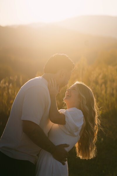 Couple laughing together in the fields