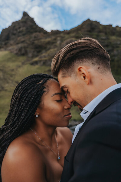 Couple embraces forehead to forehead during their Iceland elopement