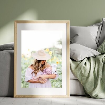 Family portrait of grandma in the middle and ten grand children ranging from newborn to teenage years