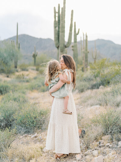 Man and woman posing with young girl in a desert