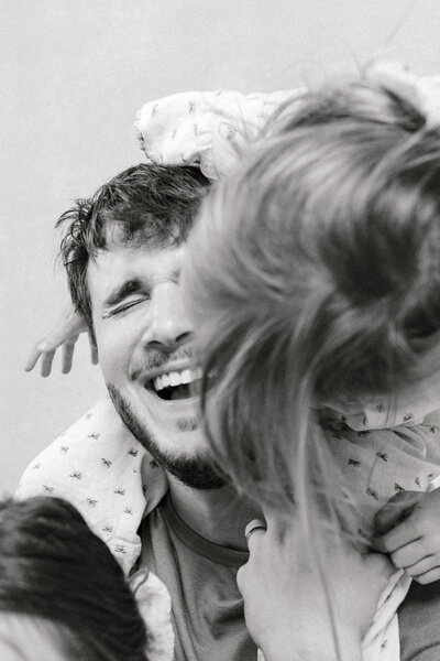 Smiling dad laughing with kids